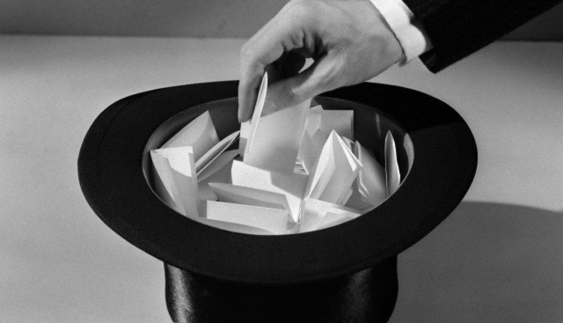 1930s man's hand in top hat full of paper pulling name out of hat