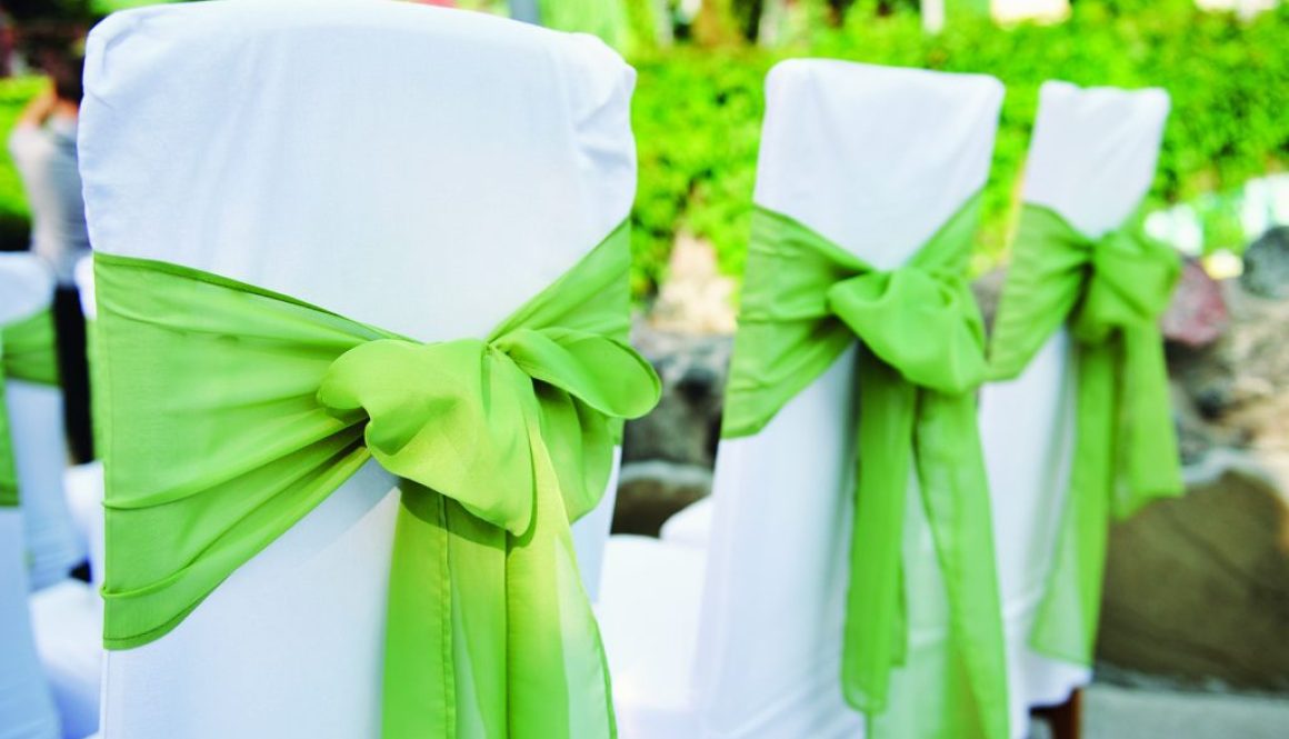 Wedding chair decorated with green color and flower.