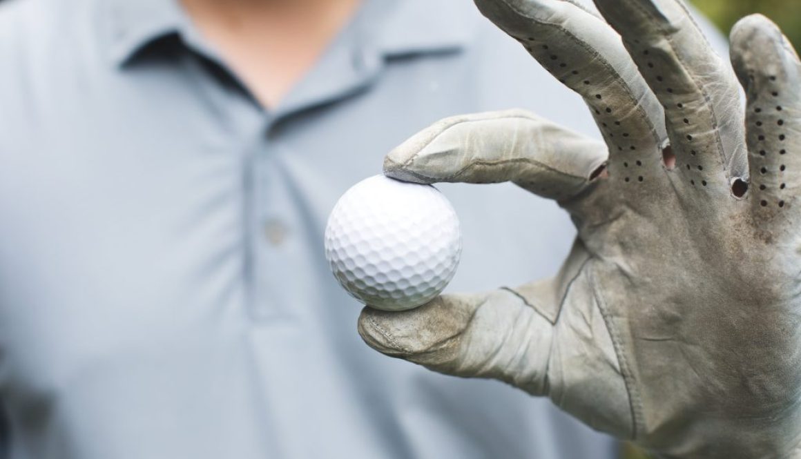 golfer-holds-golf-ball