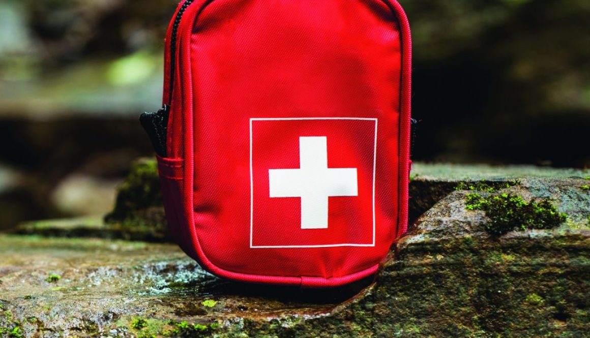 first aid kit bag on stone in nature