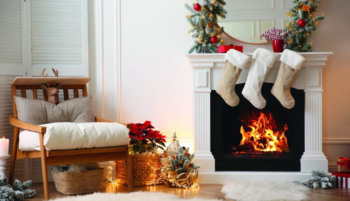 Fireplace with Christmas stockings in beautifully decorated livi