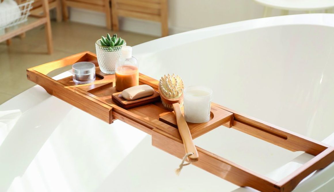 Bathtub tray with different supplies and cosmetic products