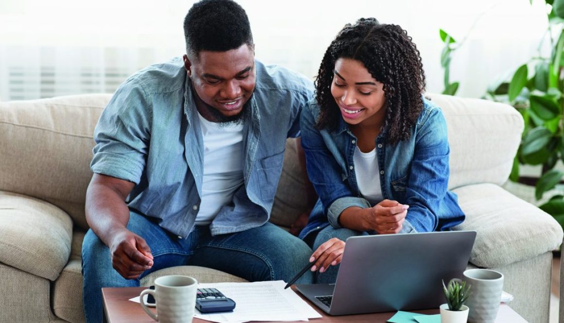 Young african spouses managing their family budget together at home