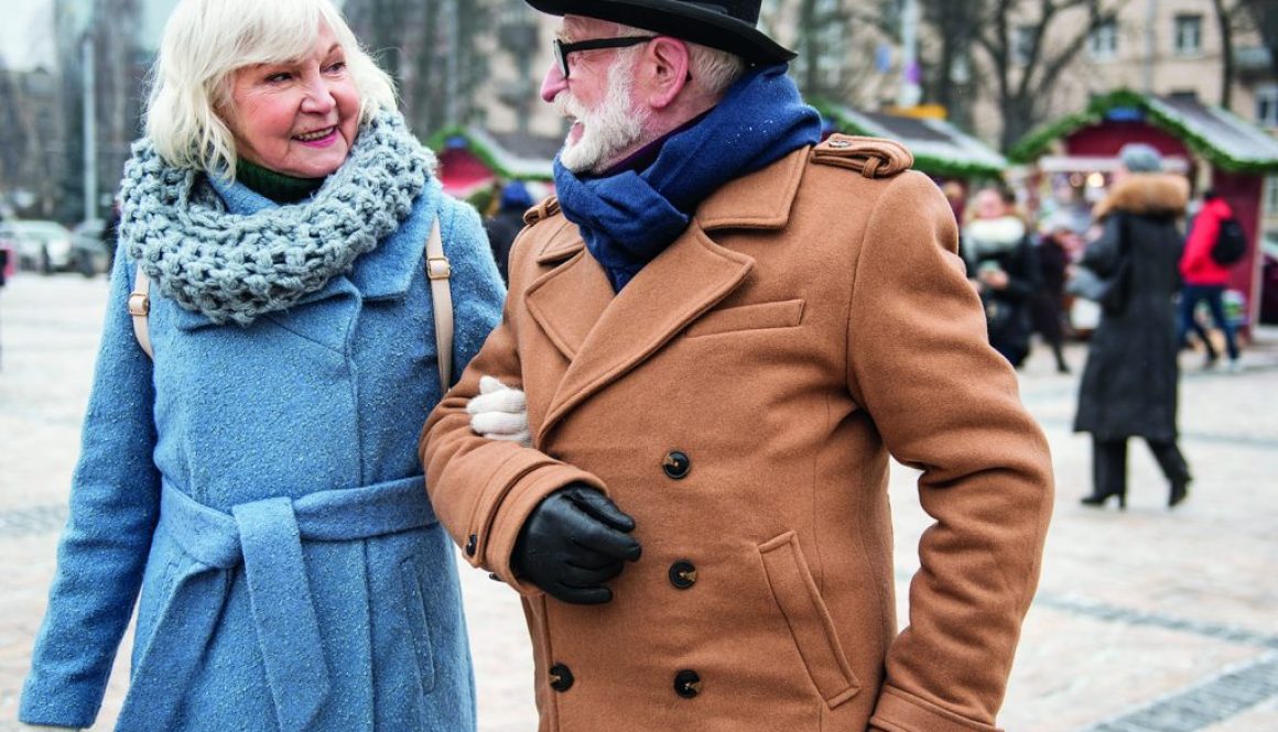 Excited old man and woman enjoying walk on street